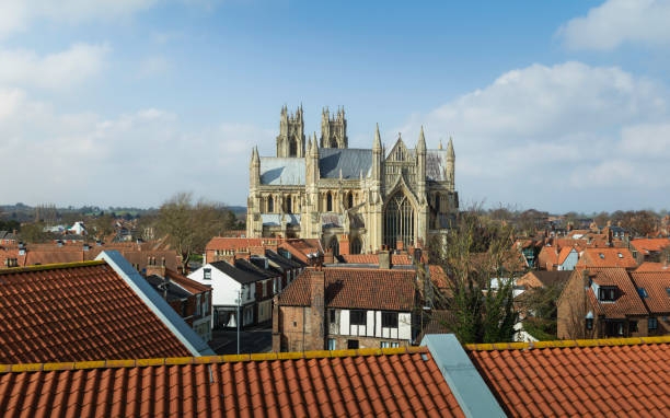 istock Elevated view of ancient minster under blue sky with clouds. 1386686842