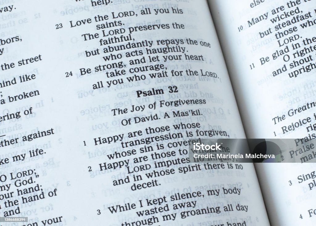 Psalm 32, the joy of forgiveness verses, open Holy Bible Book Psalm 32, the joy of forgiveness verses, open Holy Bible Book. A closeup. The Christian biblical concept of salvation and joy in God Jesus Christ. David - Biblical King Stock Photo