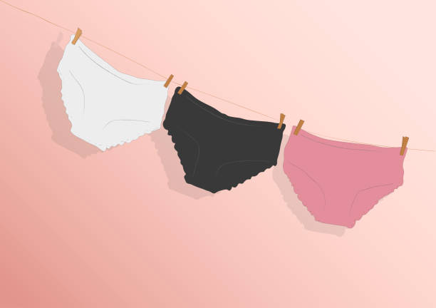 stockillustraties, clipart, cartoons en iconen met colorful clean women's panties hang on a rope. on a pink isolated background. vector illustration - damesonderbroek