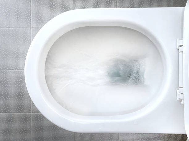 Water flushing down toilet bowl Overhead view of flushing water down the white ceramic toilet flushing stock pictures, royalty-free photos & images