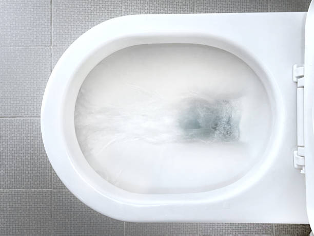 Water flushing down toilet bowl Overhead view of flushing water down the white ceramic toilet toilet bowl stock pictures, royalty-free photos & images