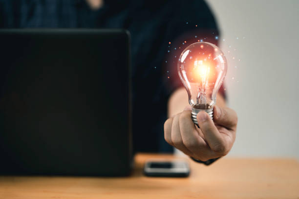 istock Businessman hand holding lightbulb with glowing light to creative smart thinking for inspiration and innovation with network concept. 1386693046