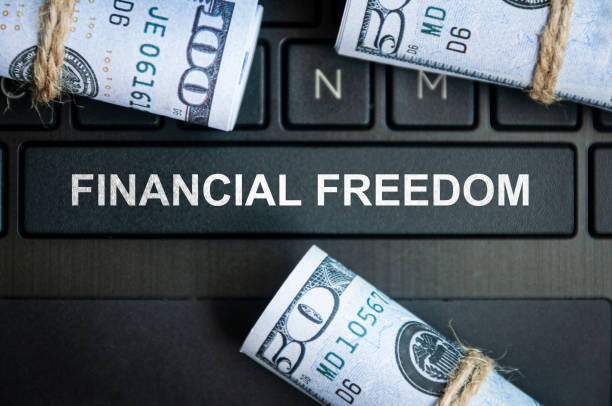 istock Financial freedom text on laptop keyboard with bank notes background. 1386693096