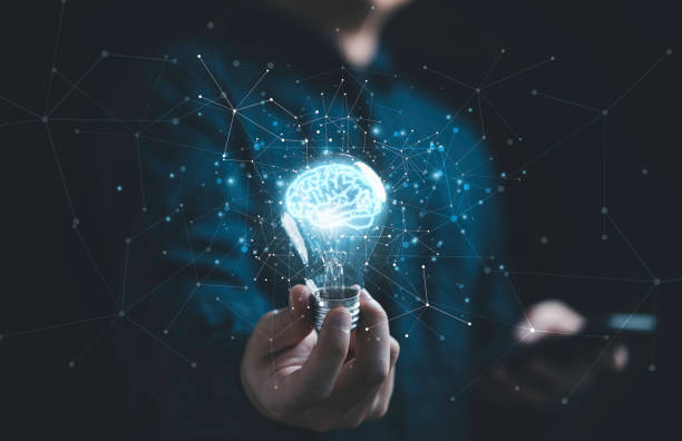 istock Businessman hand holding lightbulb with glowing virtual brain and  connection line to creative smart thinking for inspiration and innovation with network concept. 1386693143