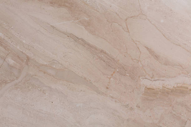 istock Ordinary natural marble texture in simple beige hue. 1386694407