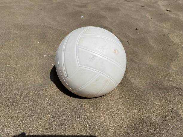 istock Bright white volley ball on the sand 1386694670