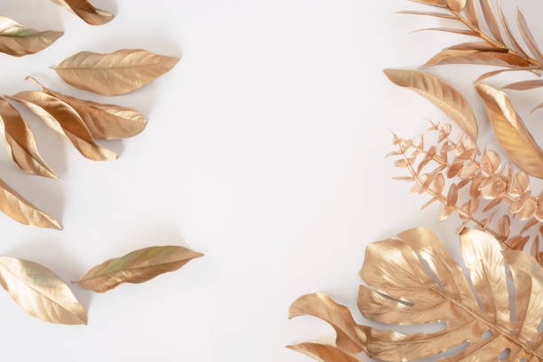 istock Gold tropical palm leaves Monstera on white background. Flat lay 1386696627
