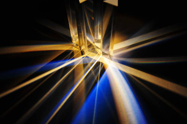 istock Triangular glass prisms dispersing of beam of artificial light. 1386697866