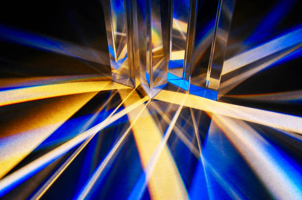 istock Triangular glass prisms dispersing of beam of artificial light. 1386697867