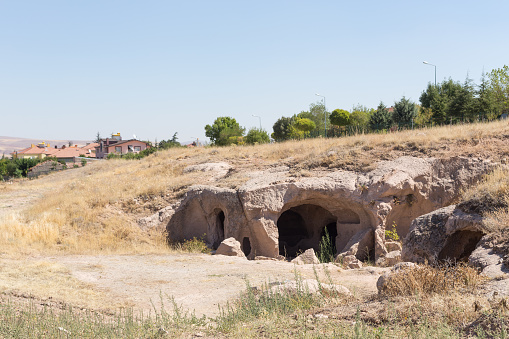 Entrance to the underground city of Derinkuyu. Natural landscape with ancient caves of an underground settlement in Turkey. Cappadocia.