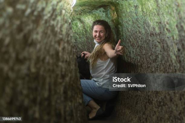 The Tourist Explores The Underground City In Cappadocia Turkey Stock Photo - Download Image Now