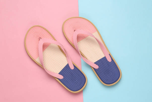 istock Colored flip flops on blue pink pastel background 1386702142