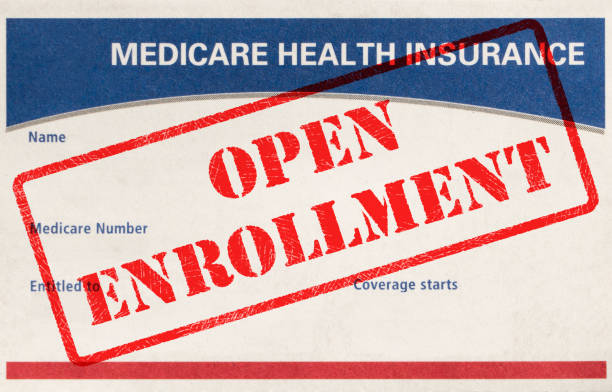 Open Enrollment Medicare Card With Rubber Stamp Open Enrollment Rubber Stamp On A Medicare Card medicare stock pictures, royalty-free photos & images