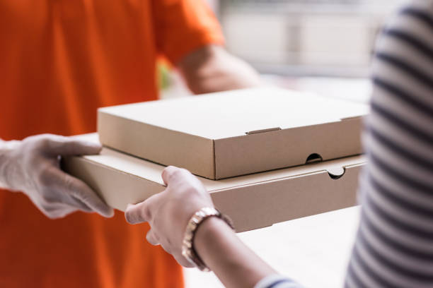 istock customer get food delivery from deliveryman. Courrier service 1386702601