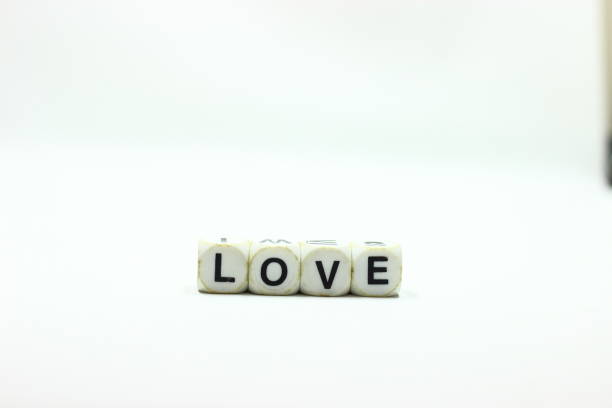istock Dice with letters forming the word LOVE on a White background 1386703917