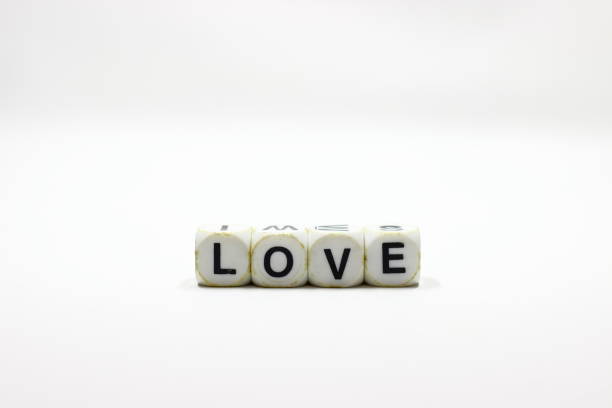 istock Dice with letters forming the word LOVE on a white background 1386703950