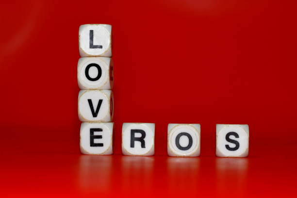 Pile of dice with letters forming the word LOVE on a red background