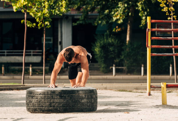 istock man flipping tire in urban area 1386708759
