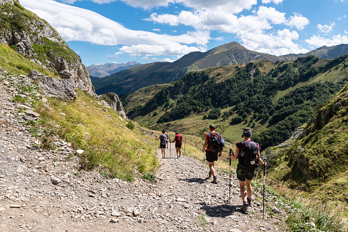 Lescun, France. 08/19/2020.  Mountaineers in the Chemin du Col de Pau. A group of friends enjoy a great summer day to make a march through the Pyrenees