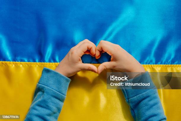 Kids Hands In A Heart Shape On The Ukrainian Flag Background Stock Photo - Download Image Now
