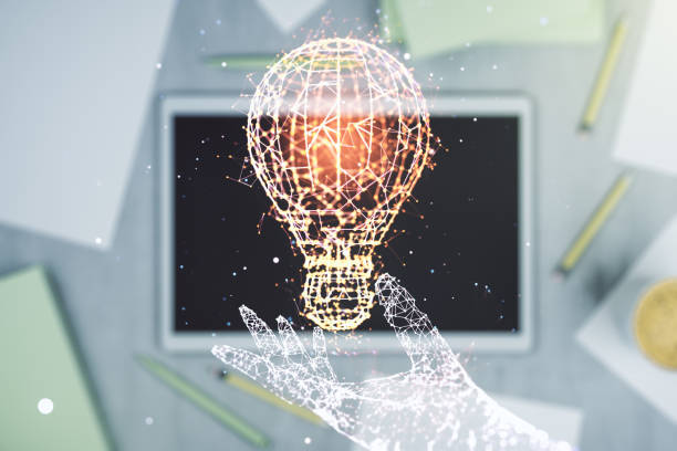istock Creative light bulb illustration and modern digital tablet on desktop on background, top view, future technology concept. Multiexposure 1386711462