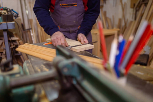 istock Unrecognizable male carpenter measuring the timber 1386711887