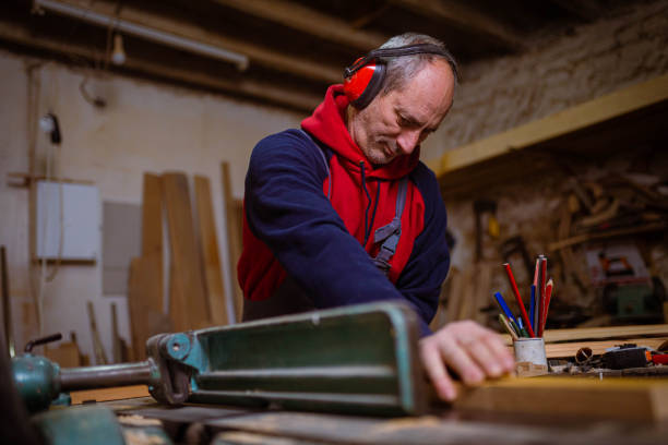 istock For his safety carpenter wear ear protectors while working with on circular sawing machine 1386711944