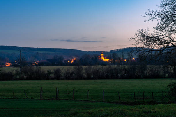 night view over the countryside towards the commune of Marigny-le-Cahouët stock photo