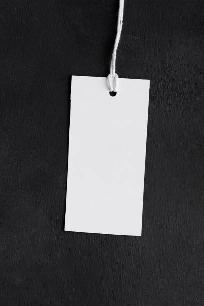 istock Blank paper rectangular price tag mockup isolated on black background, Sale and black friday concept 1386712086
