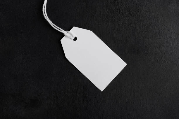 istock Blank paper rectangular price tag mockup isolated on black background, Sale and black friday concept 1386712090
