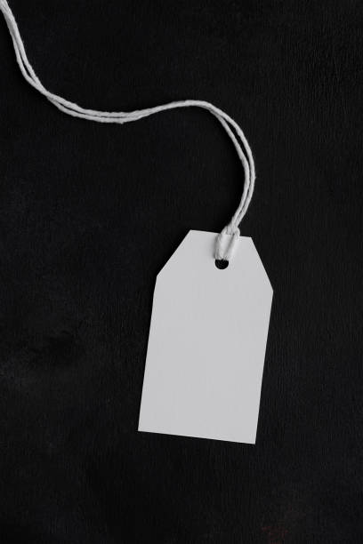 istock Blank paper rectangular price tag mockup isolated on black background, Sale and black friday concept 1386712094