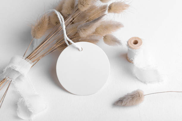 istock Round white tag mockup on a white background with cotton string and boho decoration, dry plants, element for packing 1386712892
