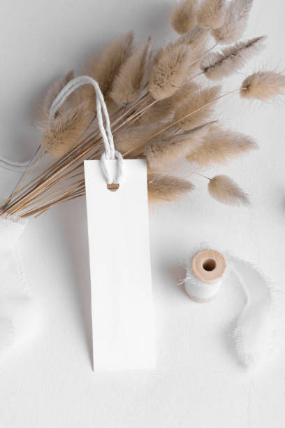 istock Rectangle white tag mockup on a white background with cotton string and boho decoration, dry plants, element for packing 1386712893