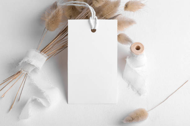 istock Rectangle white tag mockup on a white background with cotton string and boho decoration, dry plants, element for packing 1386712894
