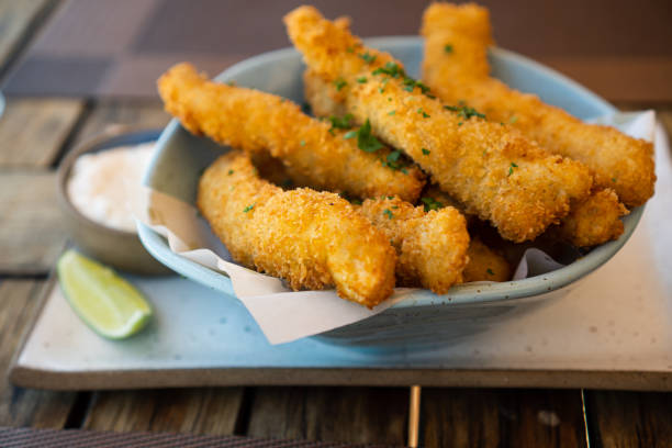 istock Fresh fried Brazilian tilapia fish strips with lime and tartar sauce known as isca de peixe. Traditional Brazilian appetizer. Selective focus 1386712910