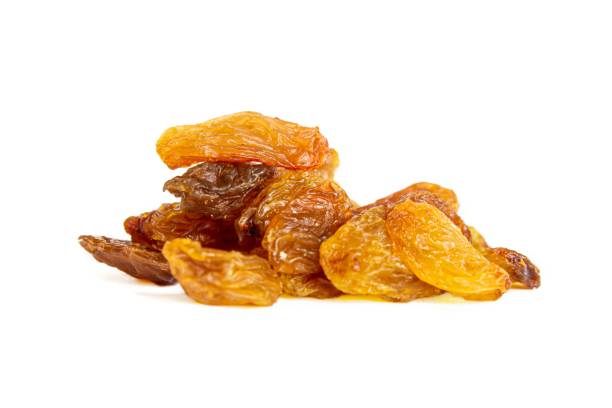 istock Yellow raisins isolated on white 1386713315
