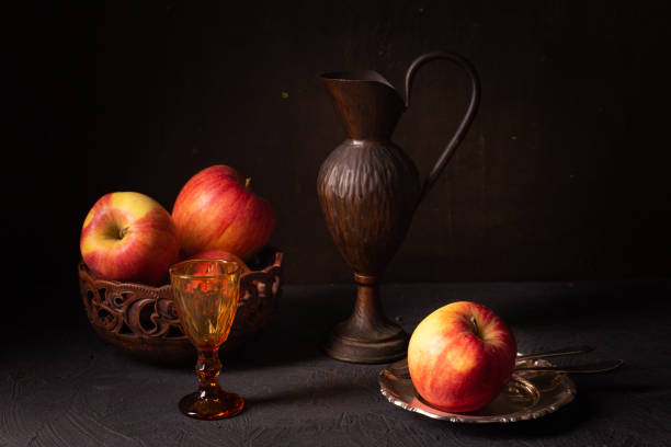 Rustic still life with apples and copper jug
