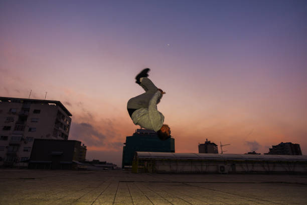 istock Roofer man doing backflip jumping outdoor 1386714438