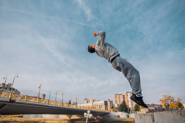 istock Sporty man perform high backflip jumping in the park 1386715378