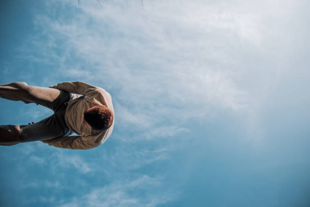 istock Free runner trains parkour below blue sky 1386715398