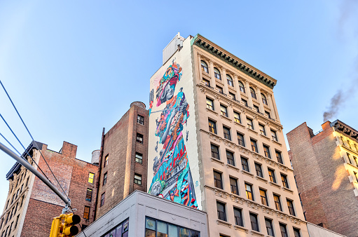 New York, New York - February 18, 2022: Buildings with murals on their walls in SOHO NYC