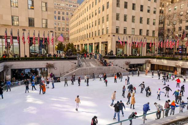 Crowds skating on the Rockefeller Centre ice rink New York, New York - February 21, 2022: Crowds skating on the Rockefeller Centre ice rink rockefeller ice rink stock pictures, royalty-free photos & images