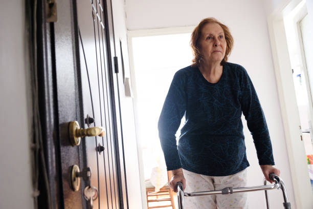 istock Senior woman with walker support is walking at home 1386715905