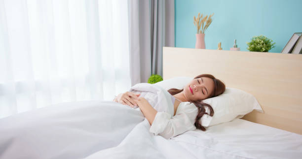 istock woman sleep well in bed 1386717349