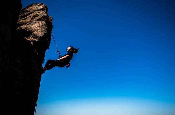 istock Female rock climber climbs on a rocky wall 1386718377