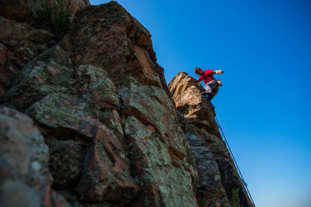 istock Young man climbing on a limestone wall 1386718384