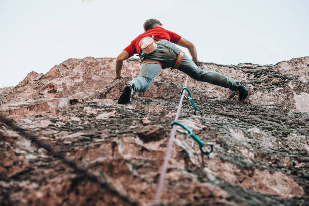 istock Climber with climbing equipment hanging on a rope 1386718650