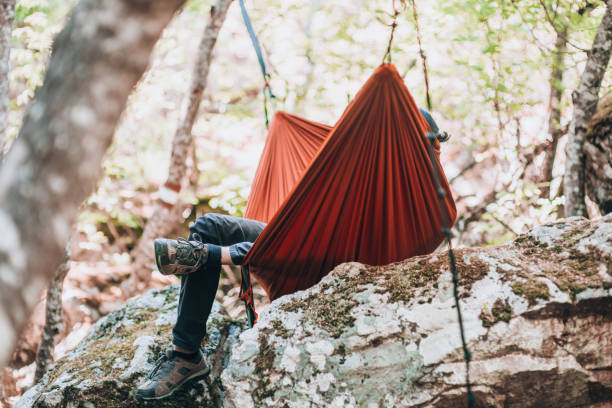 istock Man hiker relaxing in hammock 1386718666