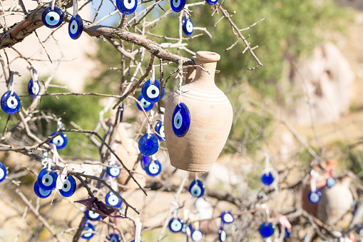 The blue eyes of Turkey are hanging from a tree in Göreme National Park in Cappadocia, Turkey.