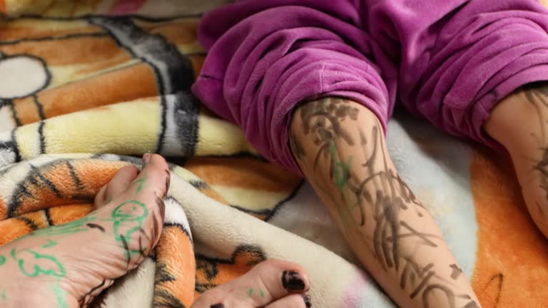 Children painting their skin with a marker